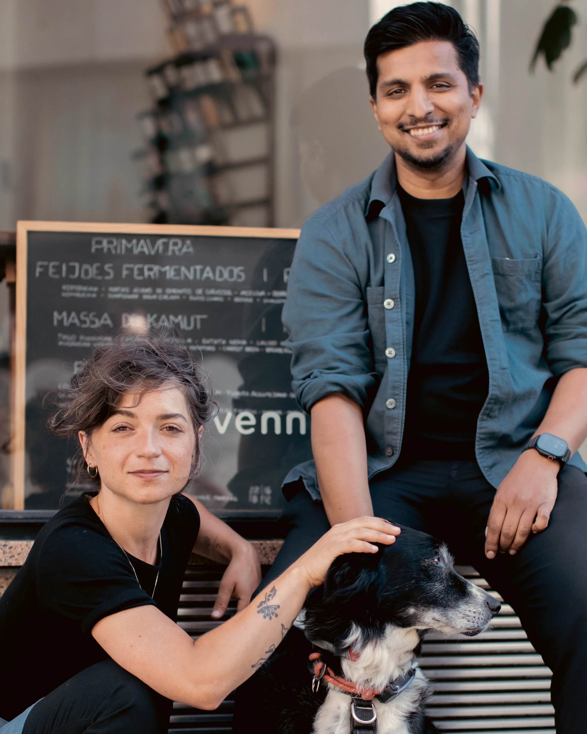 Monika Błoch and Snider Rodrigues with the restaurant dog outside VENN Canteen, Porto