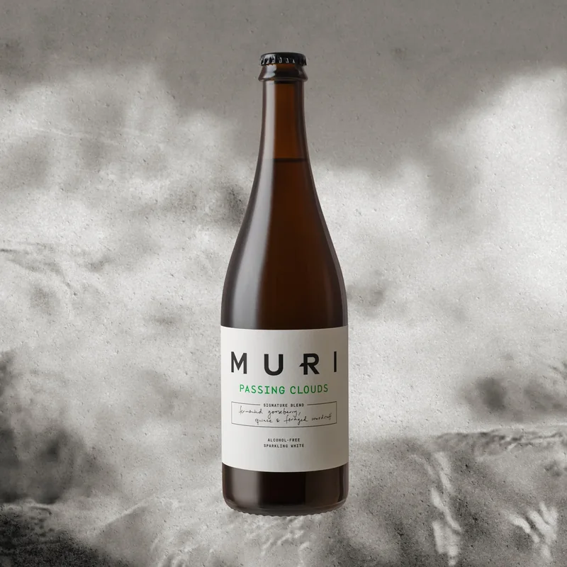 a bottle of MURI Passing Clouds against grey clouds