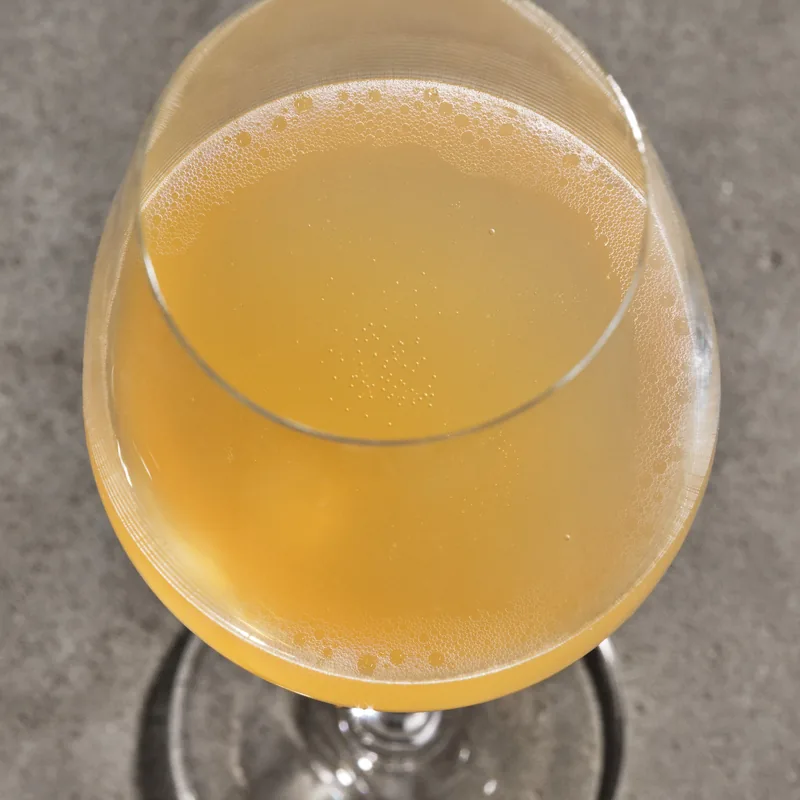 Passing Clouds in a wine glass, pale gold with fine bubbles