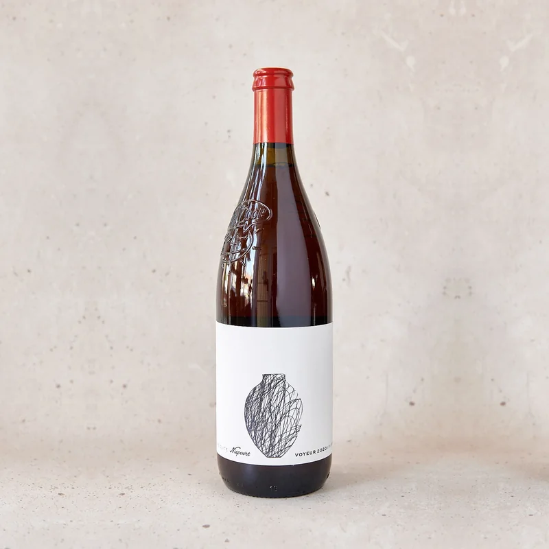 a litre bottle of Nat'Cool Voyeur, its label a scribbled drawing of an amphora, against a plaster wall