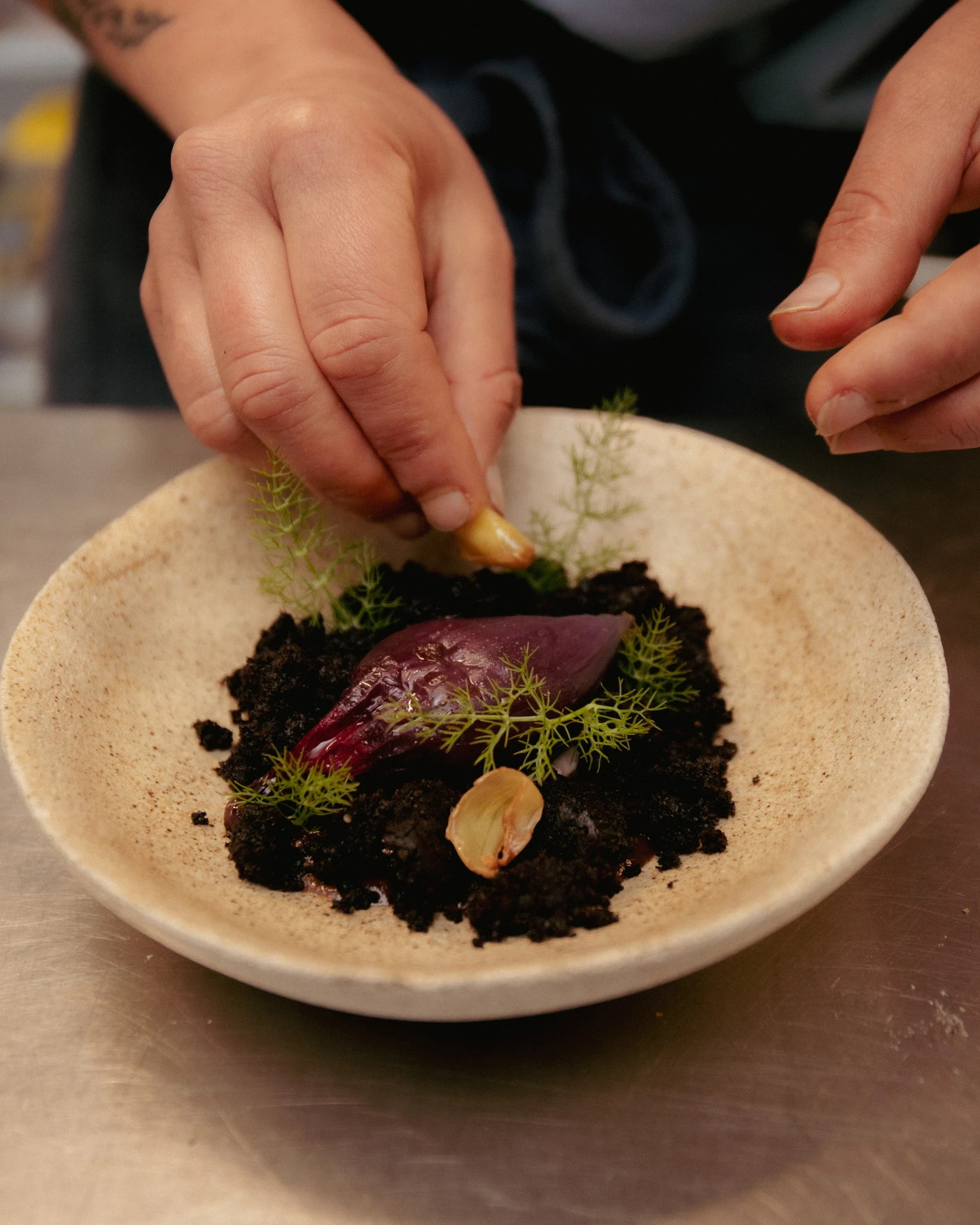 hands finishing a dish, VENN kitchen
