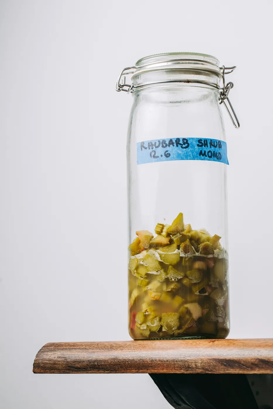 a jar of rhubarb shrub, labelled and dated